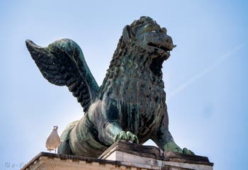 Statue of the Lion of St. Mark on the column on the Doge's Palace side of the Piazzetta San Marco in Venice