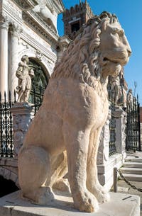 Lion of the port of Piraeus in Athens with its runic inscriptions, in front of the entrance to the Venice Arsenal